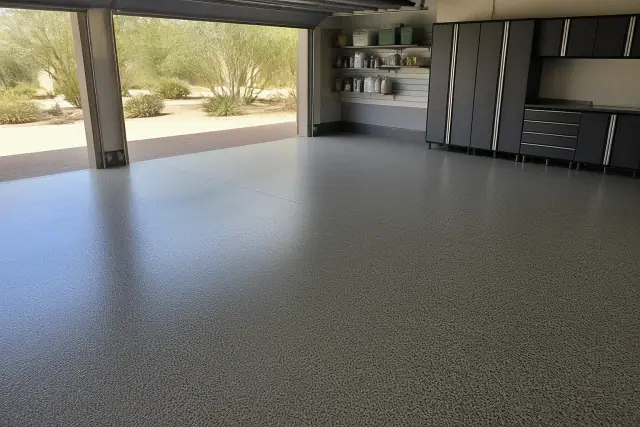 Finished epoxy flake garage floor in a residential home in Scottsdale, AZ, with desert xeriscaping visible outside.