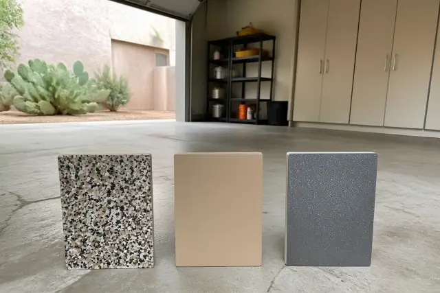 Samples of flake, solid, and metallic garage floor finishes displayed on a concrete floor in Phoenix, AZ.