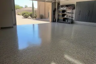 Epoxy garage floor with flake texture and desert views through the open door in Phoenix, AZ.