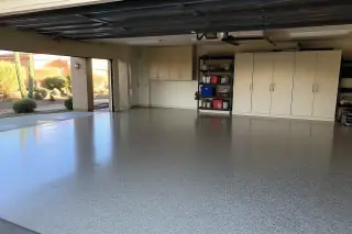 Glossy epoxy garage floor with storage cabinets and desert views in Phoenix, AZ.