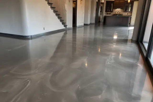Metallic epoxy flooring with swirling pigments in a sunlit open-concept kitchen in Phoenix, AZ.