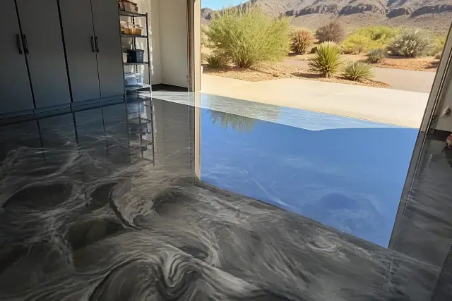 Metallic epoxy flooring with fluid swirls in a residential garage in Paradise Valley, AZ, viewed in bright sunlight.