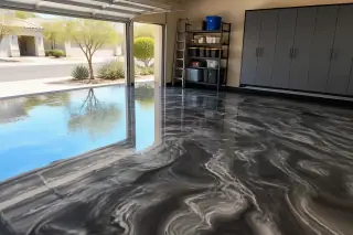 Metallic epoxy floor with a marble effect in a Phoenix, AZ garage featuring desert views through the open door.