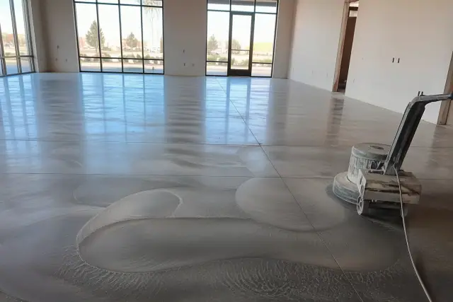 Polished concrete floor mid-process with grinding marks and a buffer in a retail space in Phoenix, AZ.