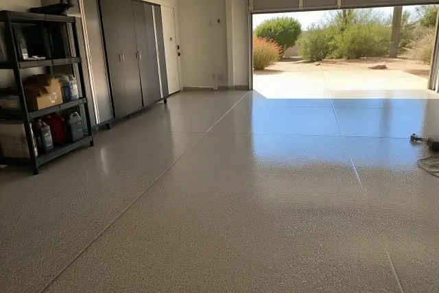 Polyaspartic floor coating curing in a residential garage in Scottsdale, AZ with desert sunlight.