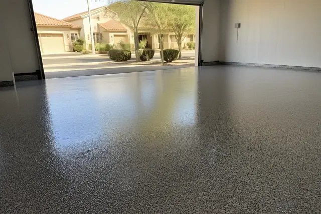 High-gloss, flake-textured polyaspartic floor coating in a residential garage in Peoria, AZ.