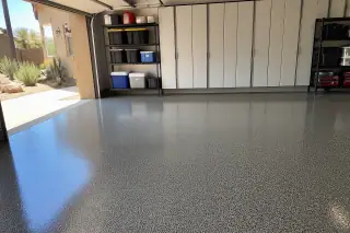Speckled polyaspartic garage floor with a view of a sunlit xeriscape yard in a Phoenix, AZ home.