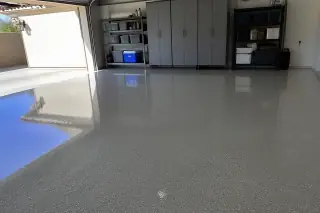 High-gloss polyaspartic garage floor with desert sun glare in a residential home in Phoenix, AZ.