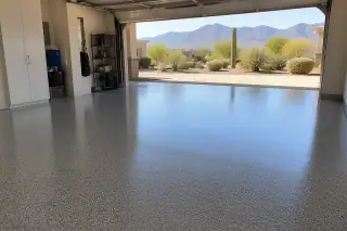 Gray-flecked epoxy garage floor with a desert mountain view through the open door in Phoenix, AZ.