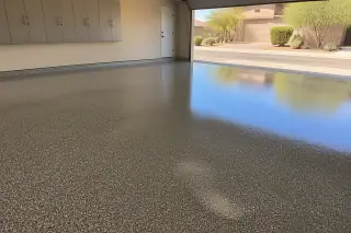 Glossy epoxy flooring in a residential garage with desert landscaping visible through the open door in Phoenix, AZ.