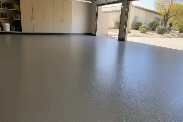 Solid-color polyaspartic floor coating in a residential garage with desert landscaping visible in Phoenix, AZ.