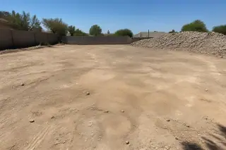 Leveled and compacted earth site after pool removal in Phoenix, AZ.