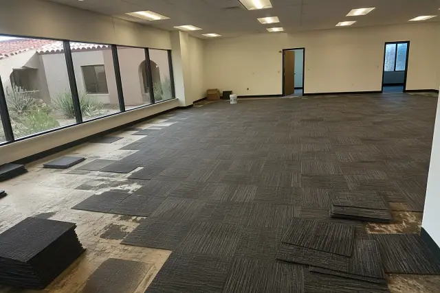 Carpet tile installation in a commercial office in Gilbert, AZ, showing desert landscaping through the window.