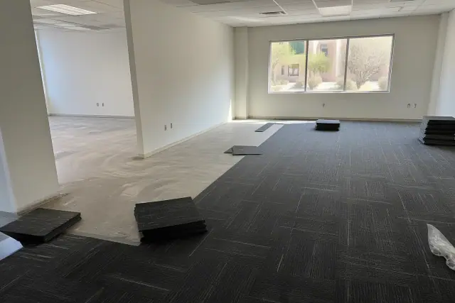 Carpet tiles being installed on an office floor in Tempe, AZ.