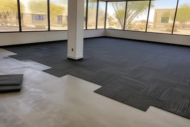 Durable carpet tiles being installed in an office workspace in Goodyear, AZ.