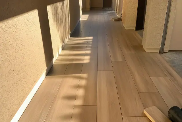 Staggered wood-look luxury vinyl plank flooring installed in a hallway in Phoenix, AZ.