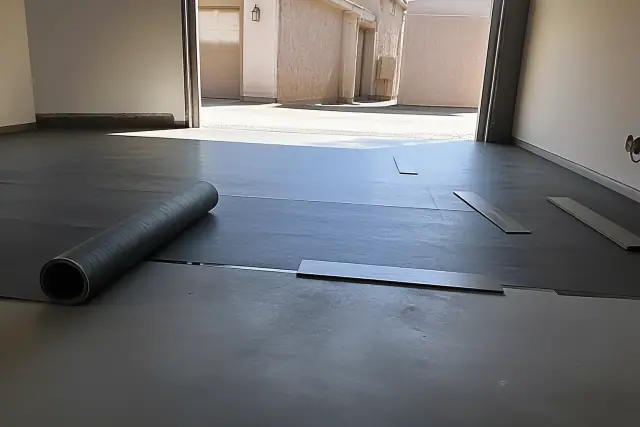 Engineered flooring planks and moisture barrier underlayment on a concrete slab at a jobsite in Phoenix, AZ.