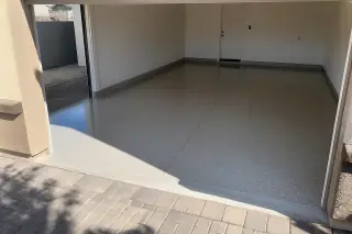 High-gloss finished epoxy garage floor in a Phoenix, AZ home with deep sunlight shadows.