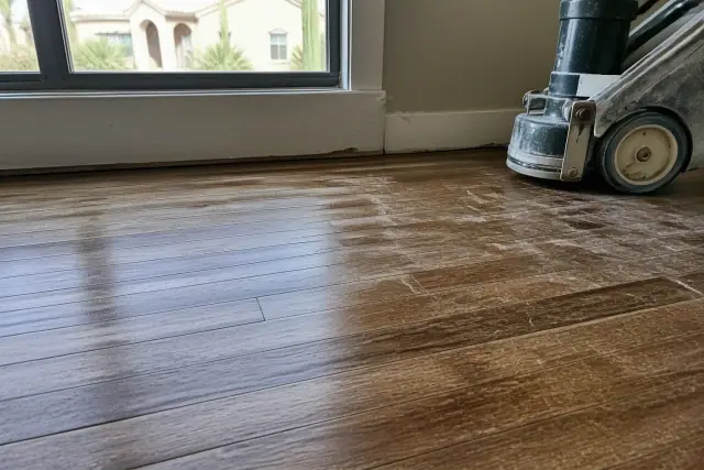 Close-up of scratches and cleaner buildup on aged hardwood floors during a home restoration project in Phoenix, AZ.