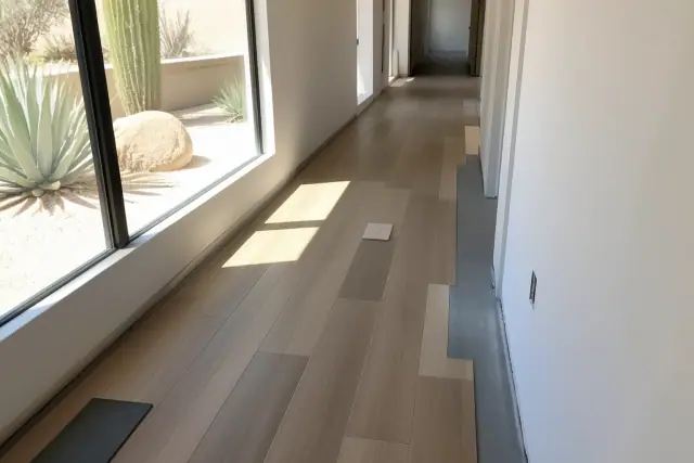 Luxury vinyl planks installed in a staggered pattern in a Scottsdale, AZ residential hallway with desert sunlight.