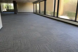 Durable carpet tiles with seamless edges installed in a commercial office workspace in Phoenix, AZ.