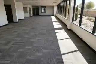 Finished carpet tile installation in a wide-open commercial office workspace in Phoenix, AZ.