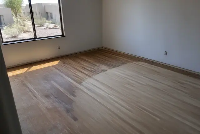 Raw wood flooring being sanded during a residential hardwood refinishing project in Chandler, AZ.