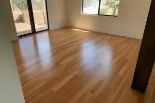 Polished hardwood flooring with visible wood grain and desert sunlight in a Phoenix, AZ project.