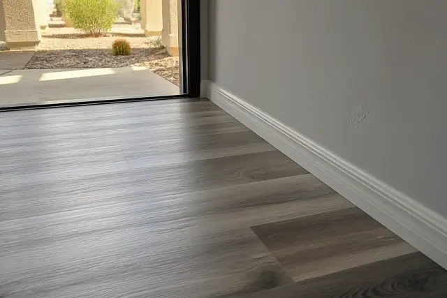 New laminate flooring installed with baseboards in a Phoenix, AZ home.