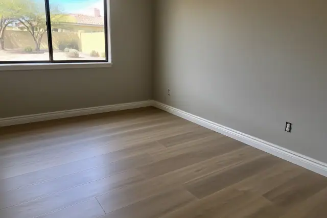 Newly installed laminate flooring and baseboards in a residential home in Chandler, AZ.