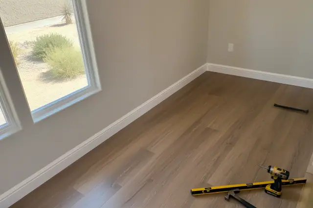 Newly installed laminate flooring and baseboards in a Surprise, AZ home.