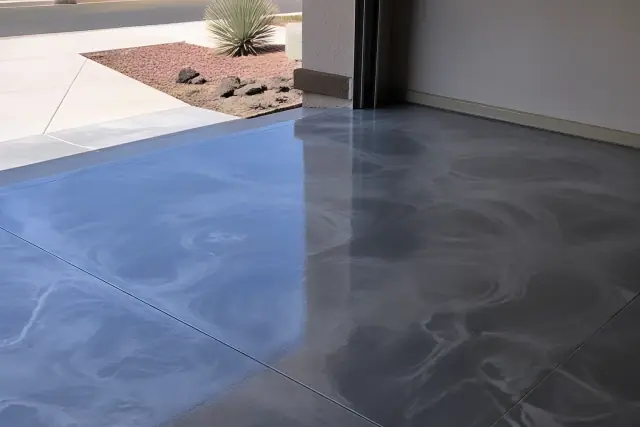 Glossy metallic epoxy garage floor with swirl patterns in a Phoenix, AZ home, featuring xeriscape landscaping.