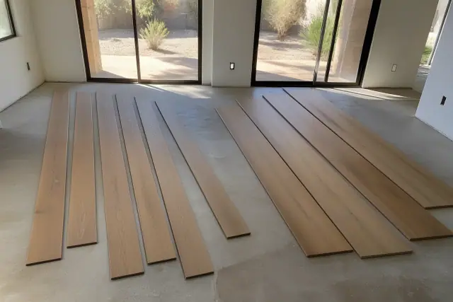 Varied width wooden planks laid on a subfloor during a renovation project in Phoenix, AZ.