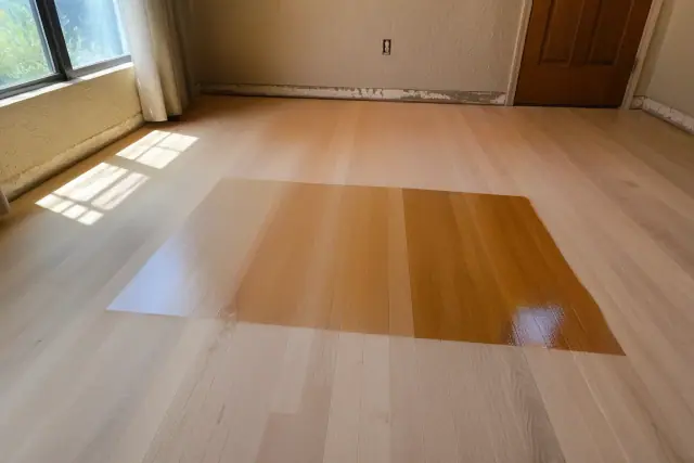 Polyurethane and sheen samples on sanded hardwood floors in a bedroom in Phoenix, AZ.