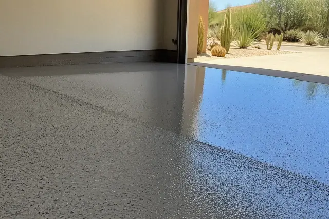 Quartz broadcast system being applied to fresh epoxy on a garage floor in Phoenix, AZ.