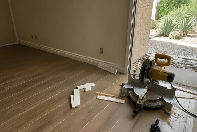 Installing laminate flooring and baseboard trim in a Phoenix, AZ home basement.