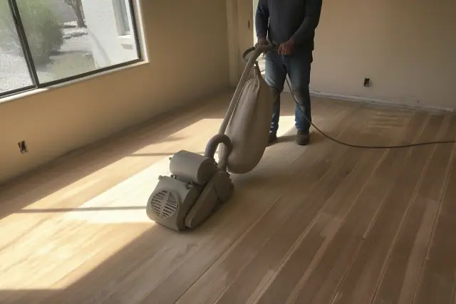 Industrial sander removing old finish from hardwood flooring in a Phoenix, AZ home.