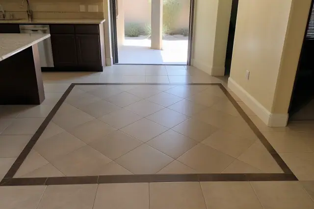 Diagonal ceramic tile flooring with a contrasting border in a residential kitchen in Phoenix, AZ.