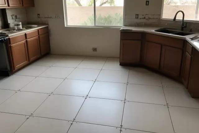 Ceramic tile flooring with spacers installed on a kitchen floor during a renovation in Goodyear, AZ.