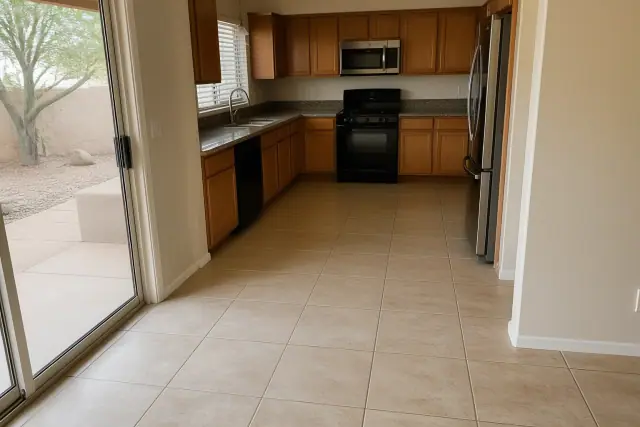Finished ceramic tile kitchen floor with clean grout lines and xeriscaped yard visible through a window in Phoenix, AZ.