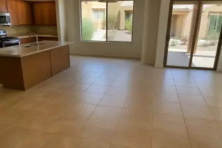 Completed ceramic tile flooring in a kitchen with desert views through the window in Phoenix, AZ.