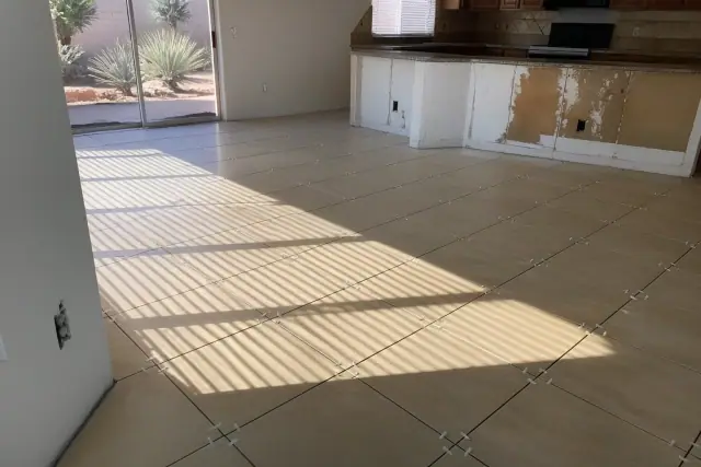 Ceramic tile flooring installation with spacers on a kitchen floor in Phoenix, AZ.