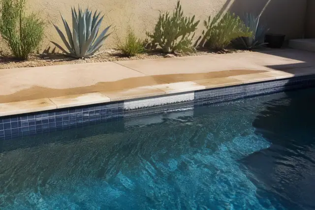 Cleaned calcium spot on swimming pool waterline tiles at a residential backyard in Phoenix, AZ.