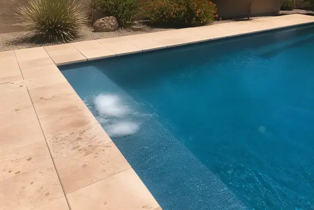 Pool shock treatment chemicals dissolving in a rectangular swimming pool at a residential backyard in Phoenix, AZ.