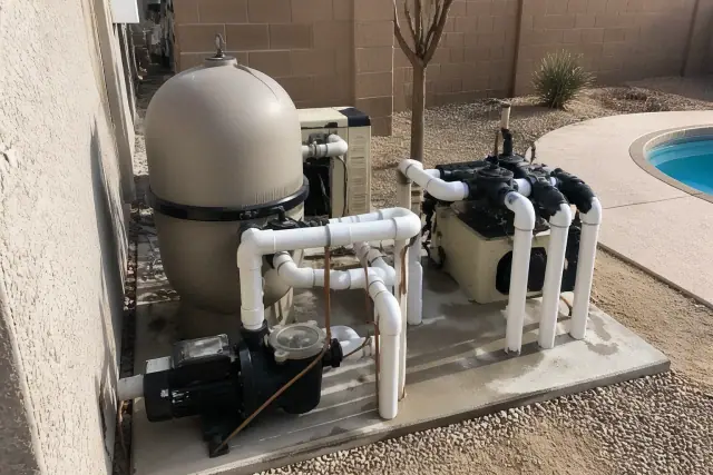 Pool filtration tanks, booster pumps, and PVC plumbing installed at a property in Phoenix, AZ.