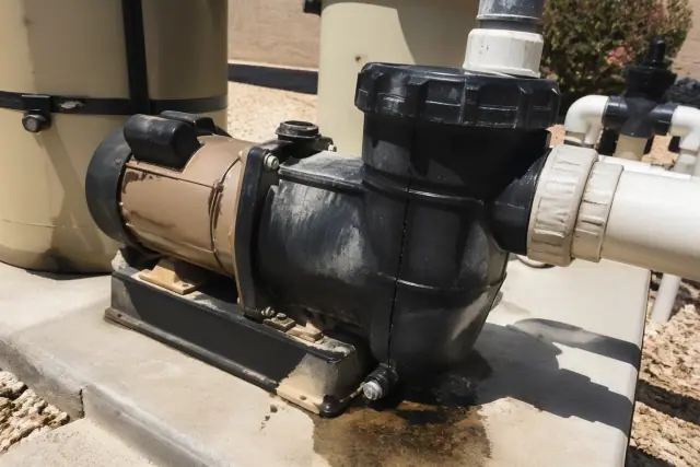 Pool pump motor housing showing a leaking shaft seal and cracked wet end in Phoenix, AZ.