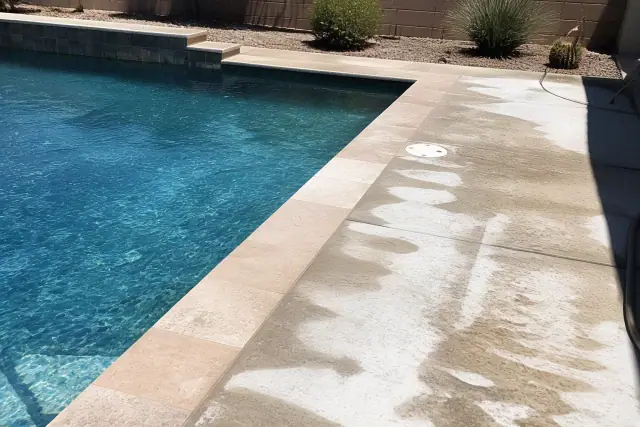 Residential swimming pool acid wash in progress with damp concrete and chemical runoff in a Mesa, AZ backyard.