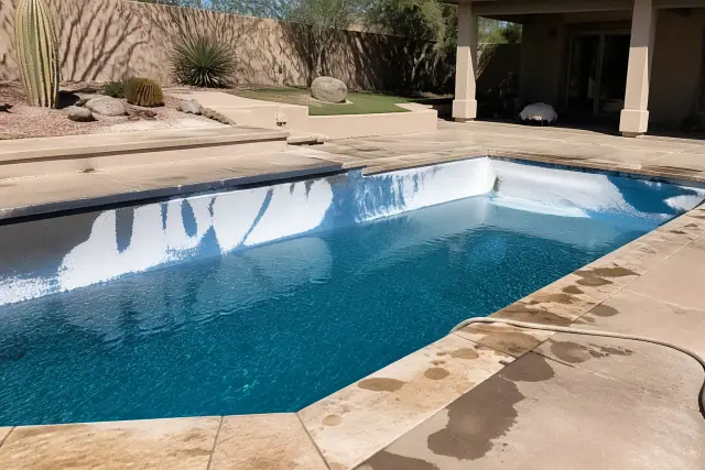 Pool acid wash in progress on a stained residential pool in Phoenix, AZ, showing treated plaster and desert landscaping.