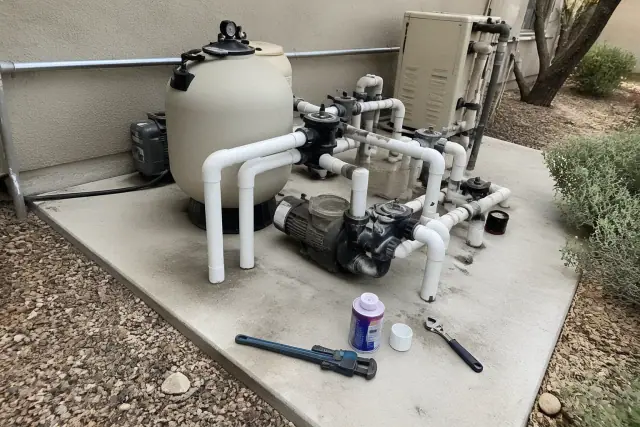 Repairing pool filtration tanks and pumps at a job site in Paradise Valley, AZ.