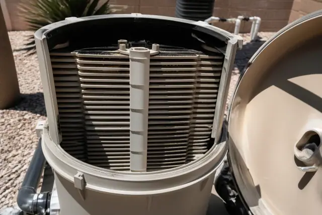 Opened pool filter housing with dirty grid cartridges during a repair job in Phoenix, AZ.